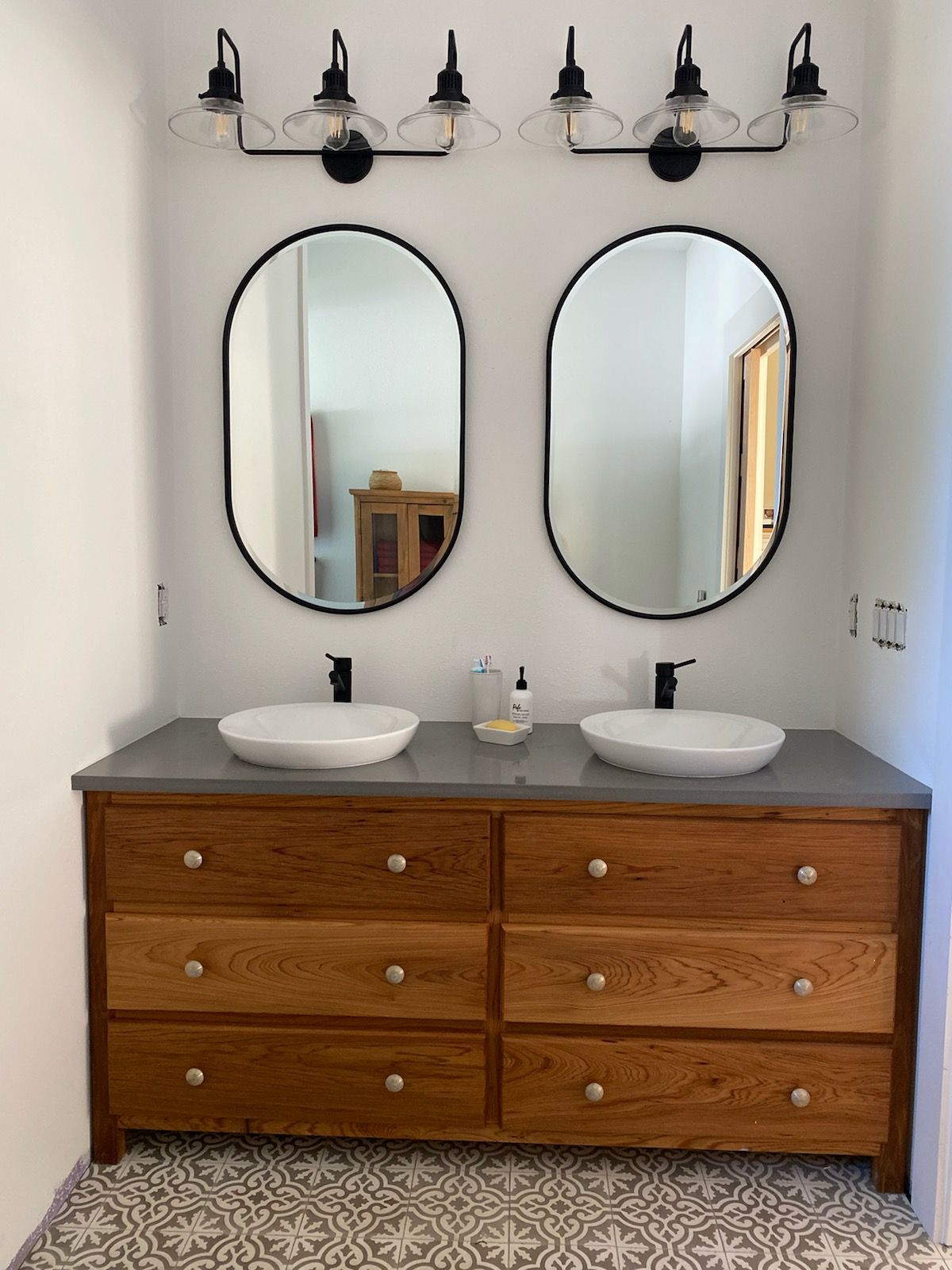 Floyd salvaged 100-year-old wood from this historic home's rehabilitation, turning it into this striking vanity. Note the grain pattern is carried across the drawer faces. That's craftsmanship!